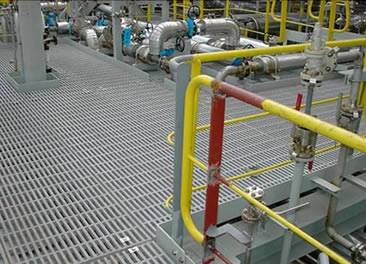 The close mesh grating forms a platform in a factory.