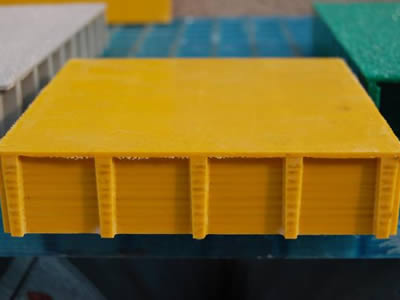 A yellow color molded covered grating on the black background.