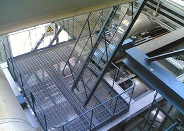 A steel structure with a platform and several stair treads.