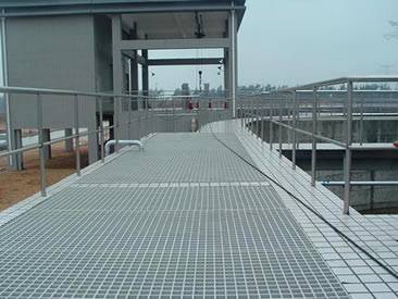 A walkway in a factory is covered by the press-locked grating.