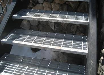 Three stair treads are made of serrated steel grating with checker plate nosing.