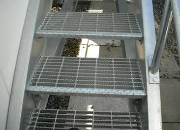 Three stair treads are made of stainless steel grating.