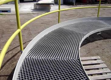 A half-circle walkway is made of stainless steel grating.