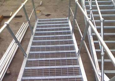 Stair treads are installed in the open-air site.