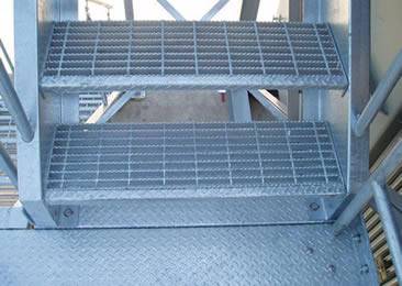 Two stair treads is made of serrated surface welded steel grating.