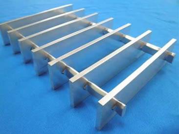 A smooth surface swage-locked grating on the blue table.