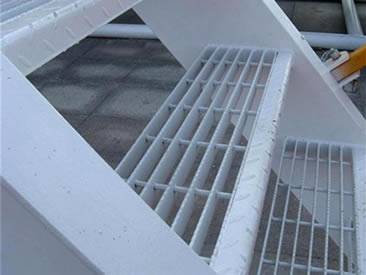 Three steps of stair treads are made of swage-locked grating.