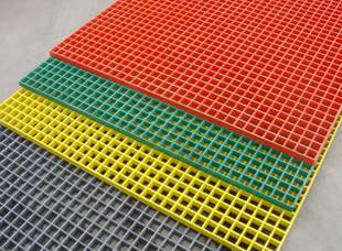 A red, a green, a yellow and a gray FRP grating on the ground.