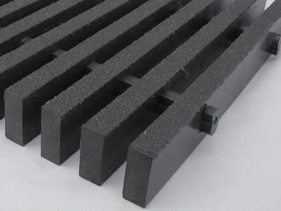 A piece of dark gray color T bar FRP pultruded grating on the gray background.