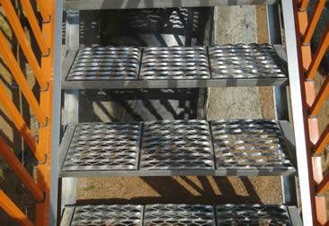 Several heavy duty diamond safety gratings are installed on the metal frame.