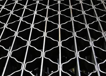 A riveted steel grating with smooth surface on the white background.