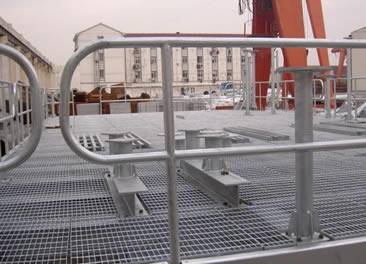 A stainless steel grating platform and a crane beside of it.