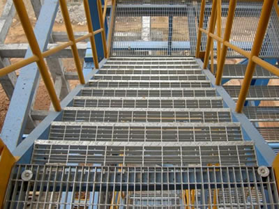 Galvanized welded steel grating stair treads with chequer plate nosing.